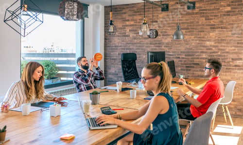 Preview: Businessmen having fun playing with a basket ball in coworking office