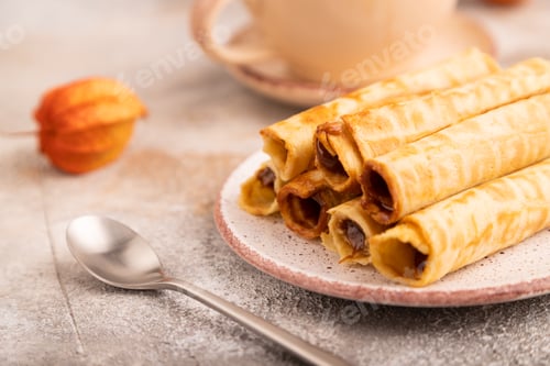Preview: Waffles with caramel on brown concrete, orange textile, cup of coffee, side view, close up