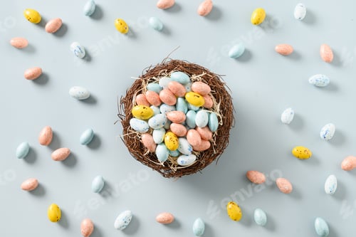 Preview: Easter composition with colorful chocolate eggs in decorative nest.