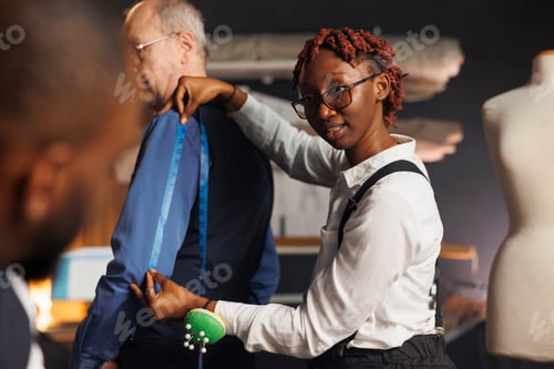 Preview: Needleworker providing arm measurements