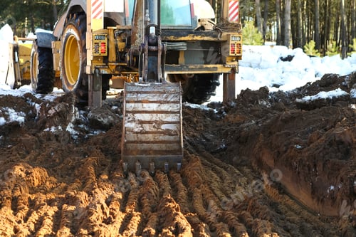 Preview: Bulldozer bucket close-up digs a pit for the construction