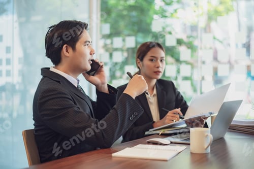 Preview: Businessman using smartphone at modern office.