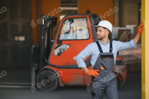Preview: Portrait of warehouse forklift driver standing in storehouse by the machine.