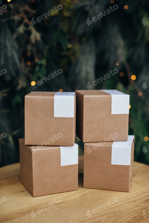 Preview: Mockup. Kraft paper boxes with white stickers on Christmas background.