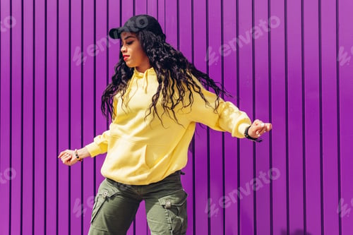 Preview: Stylish young woman in trendy outfit and hat