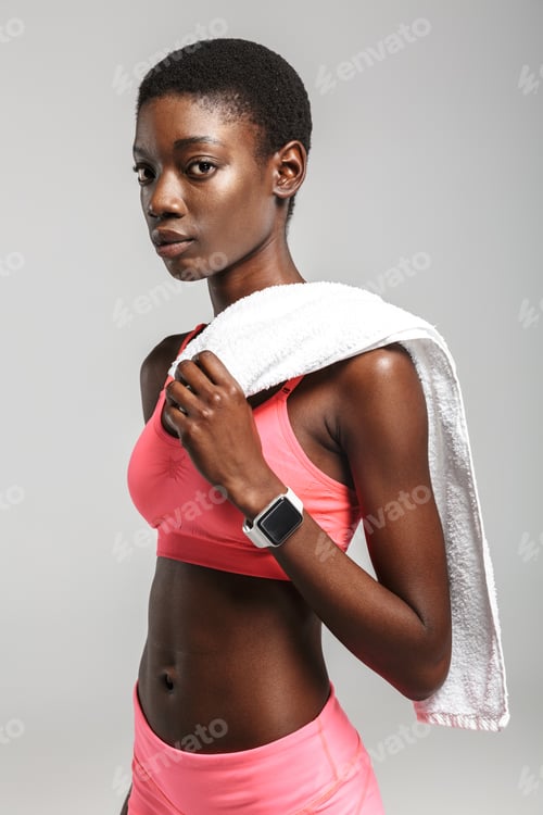 Preview: Image of african american sportswoman drinking water while working out
