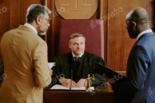 Preview: Middle Aged Caucasian Judge Listening to Lawyers Discussing Case in Courtroom