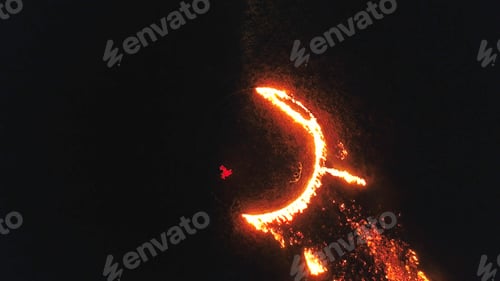 Preview: Witch in circle of fire. Stock. Top view of rite of witch in open air. Woman in red dress performs