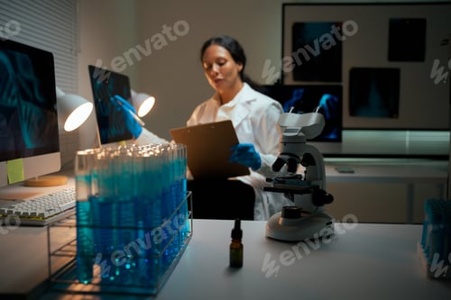 Preview: Female scientist analyzing data in laboratory