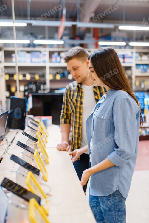 Preview: Couple choosing phones in electronics store