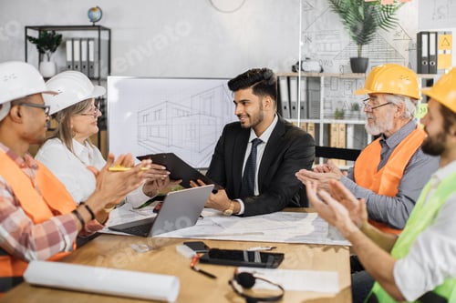 Preview: Indian businessman signs contract and documents of senior woman boss of a construction company.