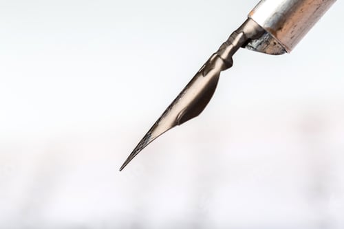 Preview: Close up of a metal calligraphy nib on a plain background during a creative session