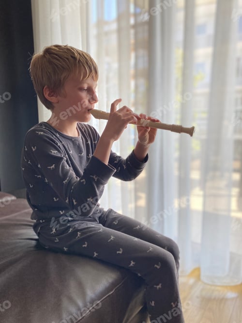 Preview: Boy Plays Recorder Indoors Near Curtain