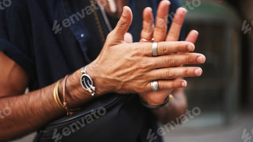 Preview: Close-up of male hands in bracelets and rings