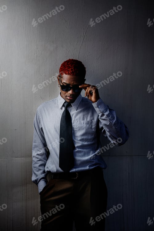 Preview: Portrait of a Latin American guy taking off sunglasses in executive suit