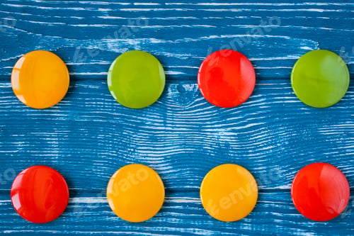 Preview: A set of colorful glass buttons for clothes on a dark wooden background