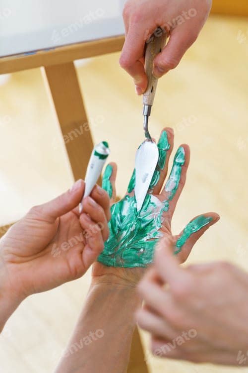 Preview: Woman drawing with her palm to create modern artwork