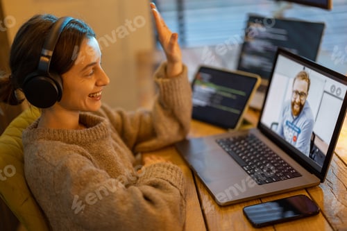 Preview: Woman talking online with a male colleague at home office