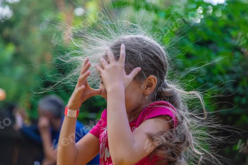 Preview: The child hair was electrified. Selective focus.