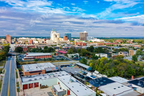 Preview: Beautiful view of Greensboro, North Carolina skyline with a cloudy sky in the background