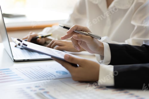 Preview: Businesswoman meeting financial advisor discuss business growth chart analysis in financial report.