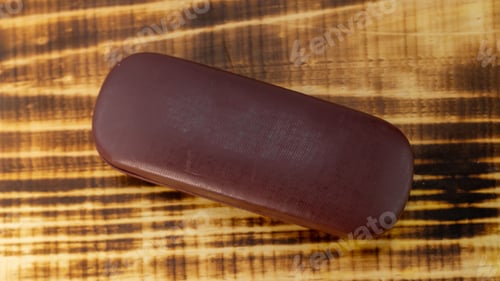 Preview: Shot of the wooden base lens case in a white background.