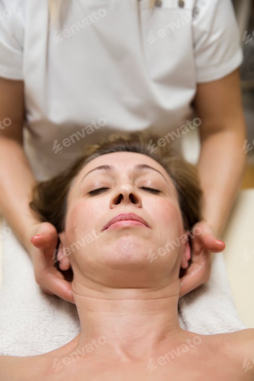 Preview: Closeup face of a woman having facial massage at spa