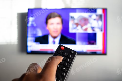 Preview: Closeup shot of a person holding a remote control