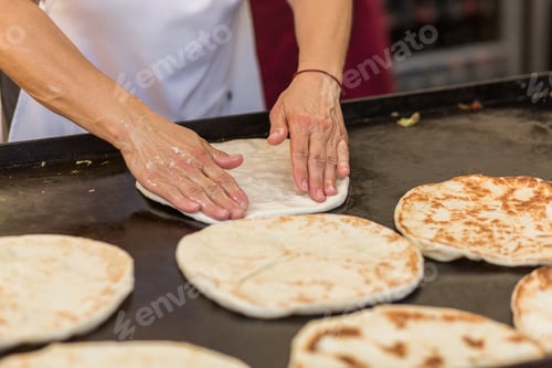 Preview: woman prepares a flatbread at the traditional street food festival in Budapest