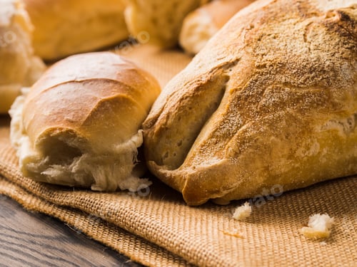 Preview: Freshly baked bread on burlap dark wooden background