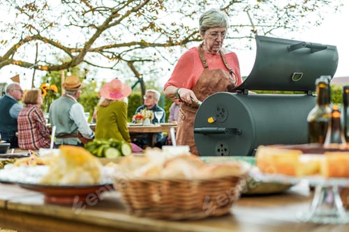 Preview: Senior Picnic: Woman at the BBQ with Friends in the Countryside
