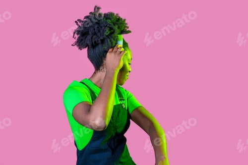 Vista previa: Young black woman dancing feeling free wearing wireless headphones isolated background