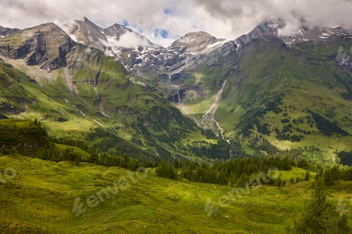 Preview: Grossglockner. Serpentine alpine road viewpoint. Green forest and waterfall. Austria