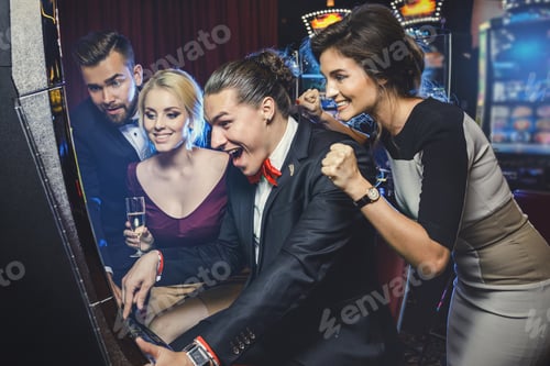 Preview: Group of friends playing slot machines in casino