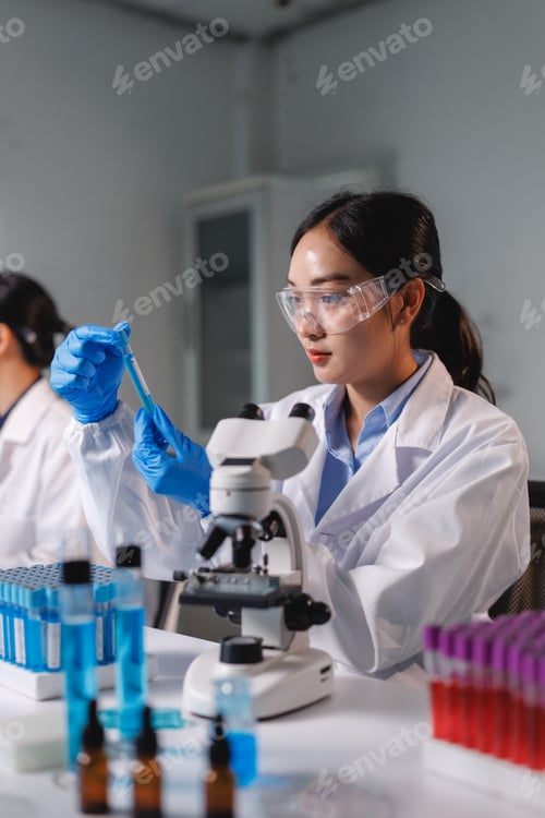 Preview: Scientist holding test tube and analyzing liquid solution in laboratory