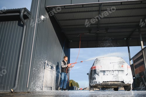 Preview: Car is washed at a professional car wash. Man washes a car with foam. Detailing