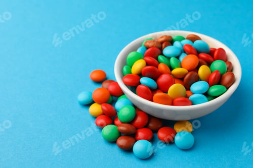 Preview: Tasty colorful candies on blue background, closeup. Space for text