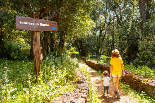 Preview: A mother with her son next to a sign identifying the La Llania trekking trail in El Hierro, Canary