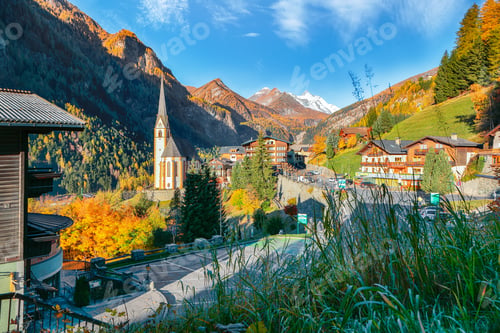 Preview: Picturesque autumn landscape at Heiligenblut with St Vincent Church near Grossglockner mount .