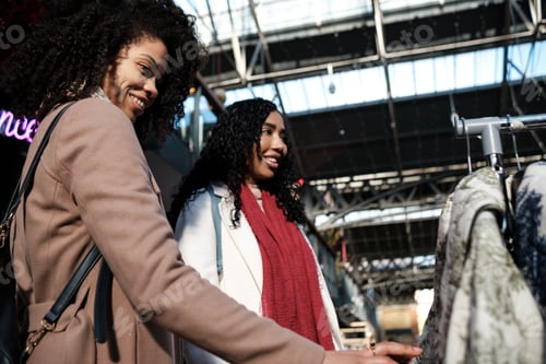 Preview: Two female friends shopping in a flea market.