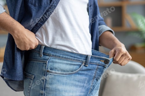 Preview: Man shows off big pants, weight loss and active lifestyle successful achievements. Man close up at
