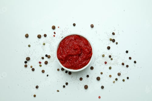 Preview: Bowl with tomato paste, pepper and salt on white background