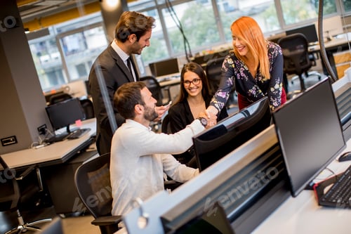 Preview: Group of young business people are working together with desktop computer