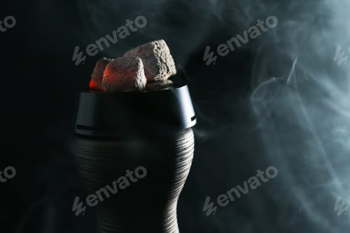 Preview: Smoldering charcoal cubes in hookah holder and smoke on dark background, closeup