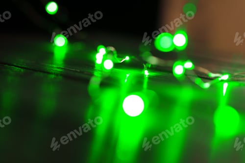 Preview: Garland with green light elements in the dark close up