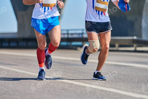 Preview: Athletes running down road, low angle view