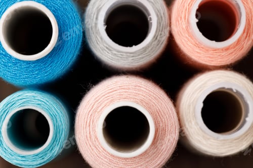 Preview: Close up of colored thread coils, thread spools background