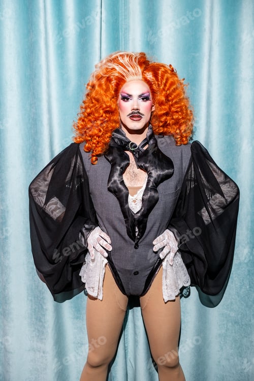 Preview: Stylish Drag Performer Poses Confidently in Elegant Outfit With Vibrant Hair
