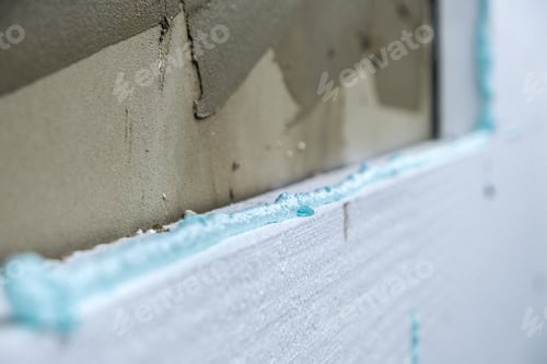 Preview: Installation of styrofoam insulation sheets on house facade wall for thermal protection