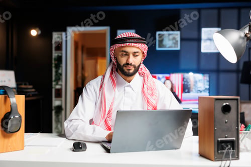 Preview: Arab businessman using wireless laptop